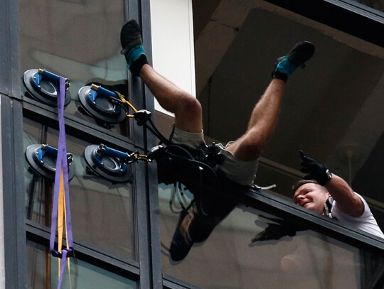 A man climbs Trump Tower in New York City