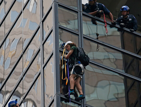 A man climbs Trump Tower in New York City