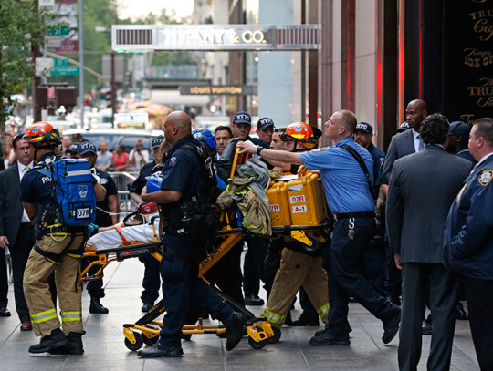 A man climbs Trump Tower in New York City