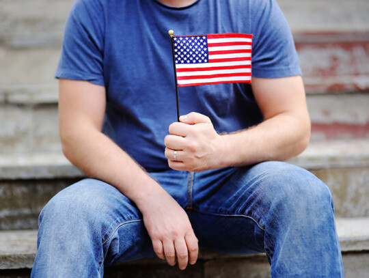 Handsome man holding american flag