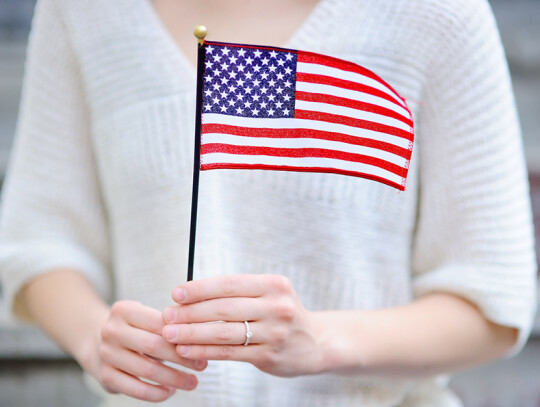 Young Woman Holding American Flag