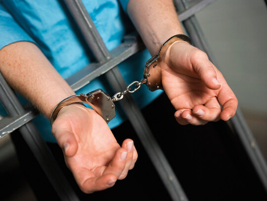 Woman's Hands Fettered With Handcuffs