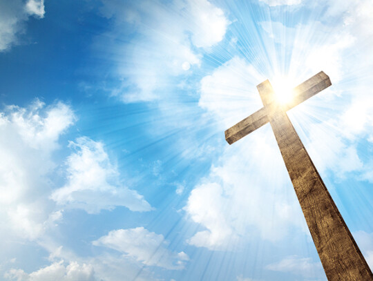 A wooden cross with sky