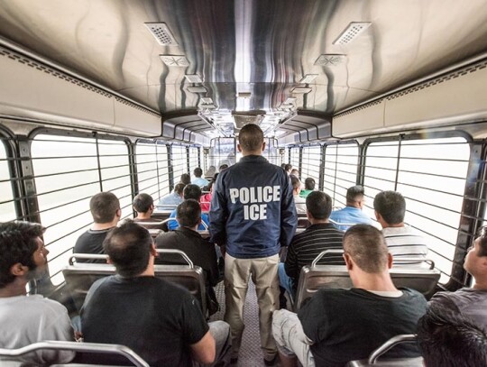 An ERO officer escorts aliens headed to an ICE detention facility in Chicago, Ill.   