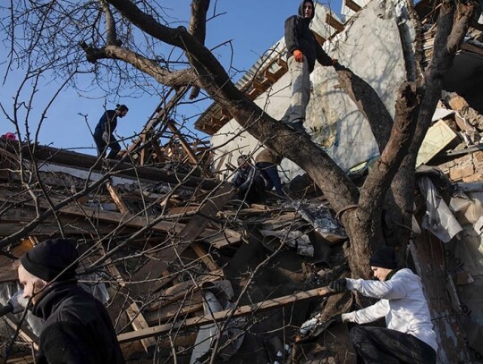 Volunteers clear debris at the site of a Russian New Year's Eve missile attack in Kyiv, Ukraine - 03 Jan 2023