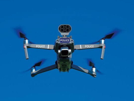 Police unmanned aircraft system, Drone flying, blue sky background