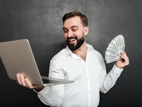 Portrait of successful businessman in white shirt holding fan of