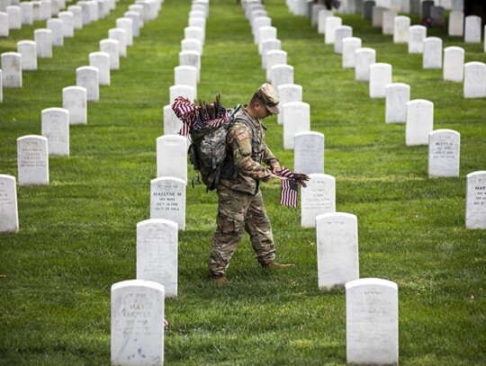 Soldiers places American flags on headstones in Arlington National Cemetery, USA - 25 May 2017